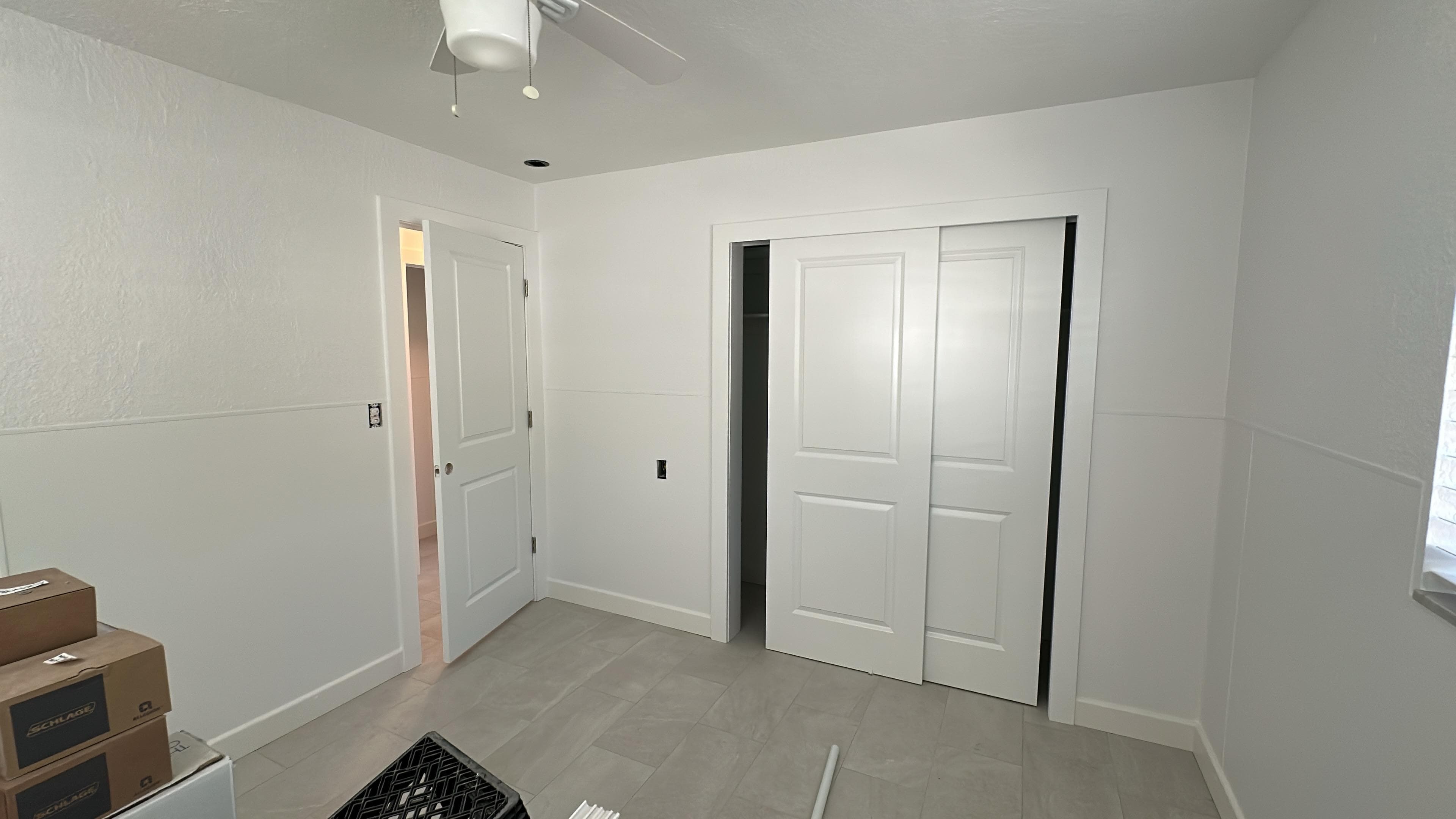 Finished bedroom repaint with bright white walls, doors, trim, and a clean modern look
