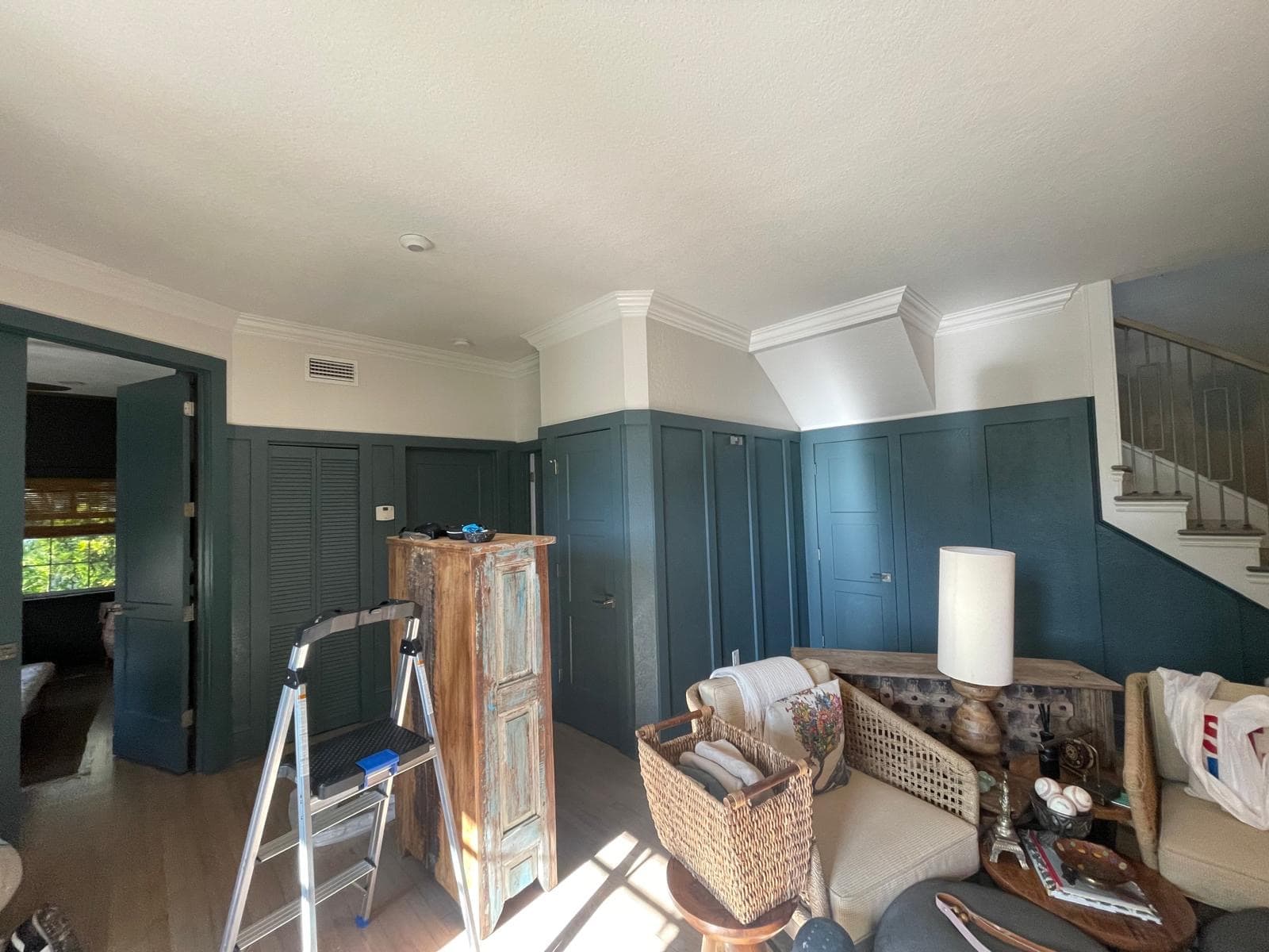 Interior repaint with rich blue-green paneling, matching doors, and crisp white upper walls