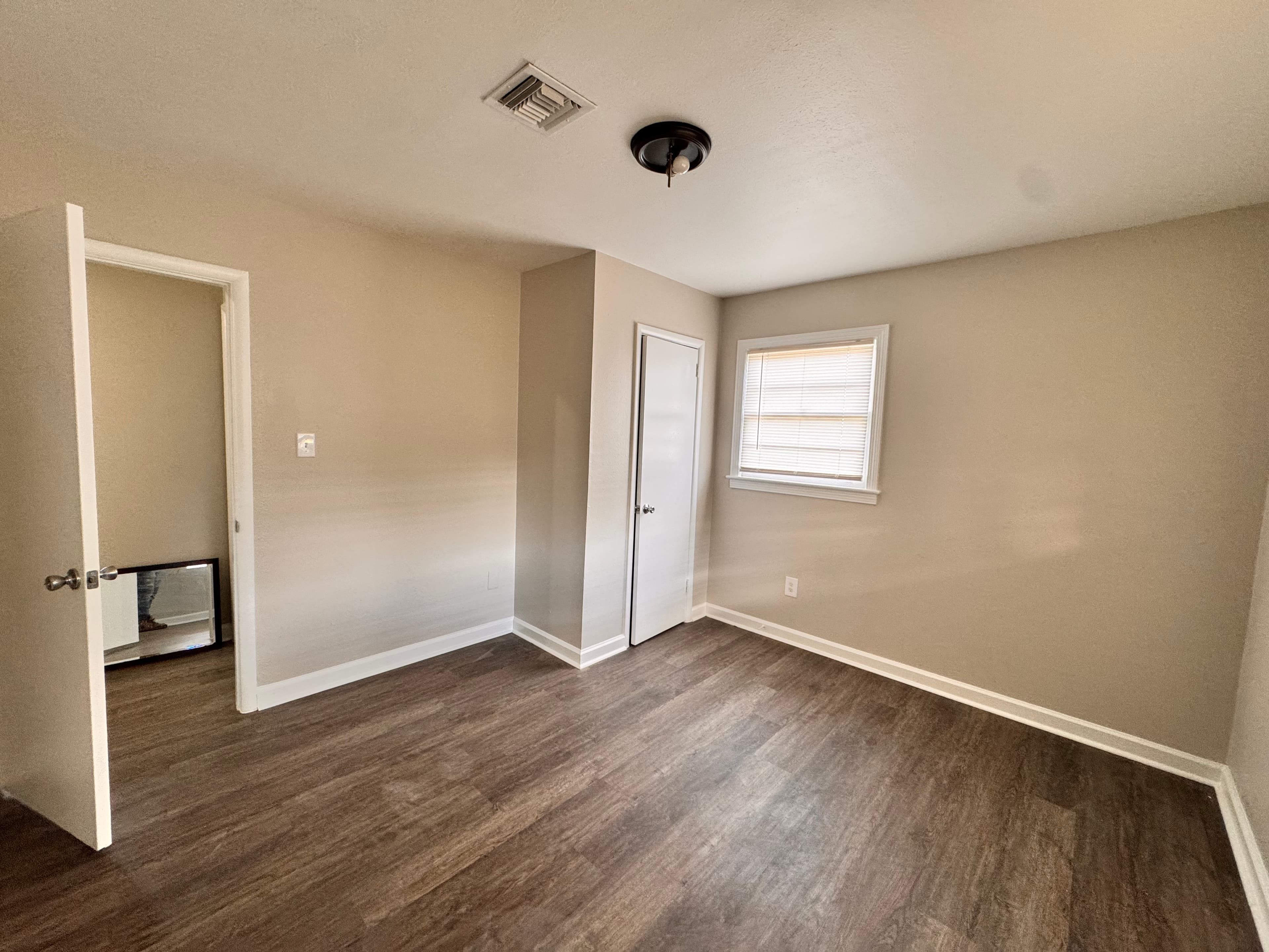 Refreshed bedroom with soft neutral paint, bright trim, and a clean move-in-ready finish.