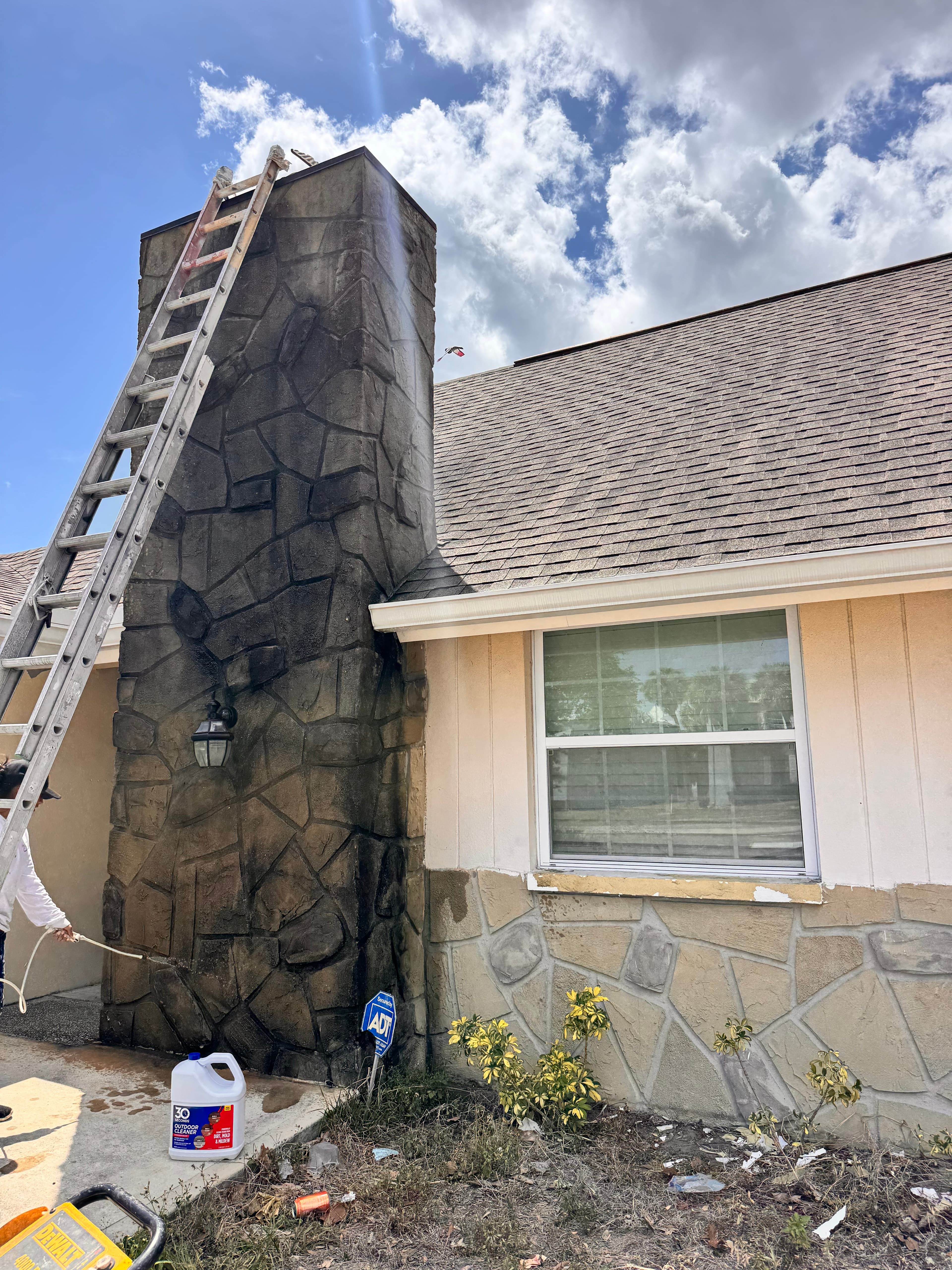 Before photo of residential home front angle with faded trim and worn siding