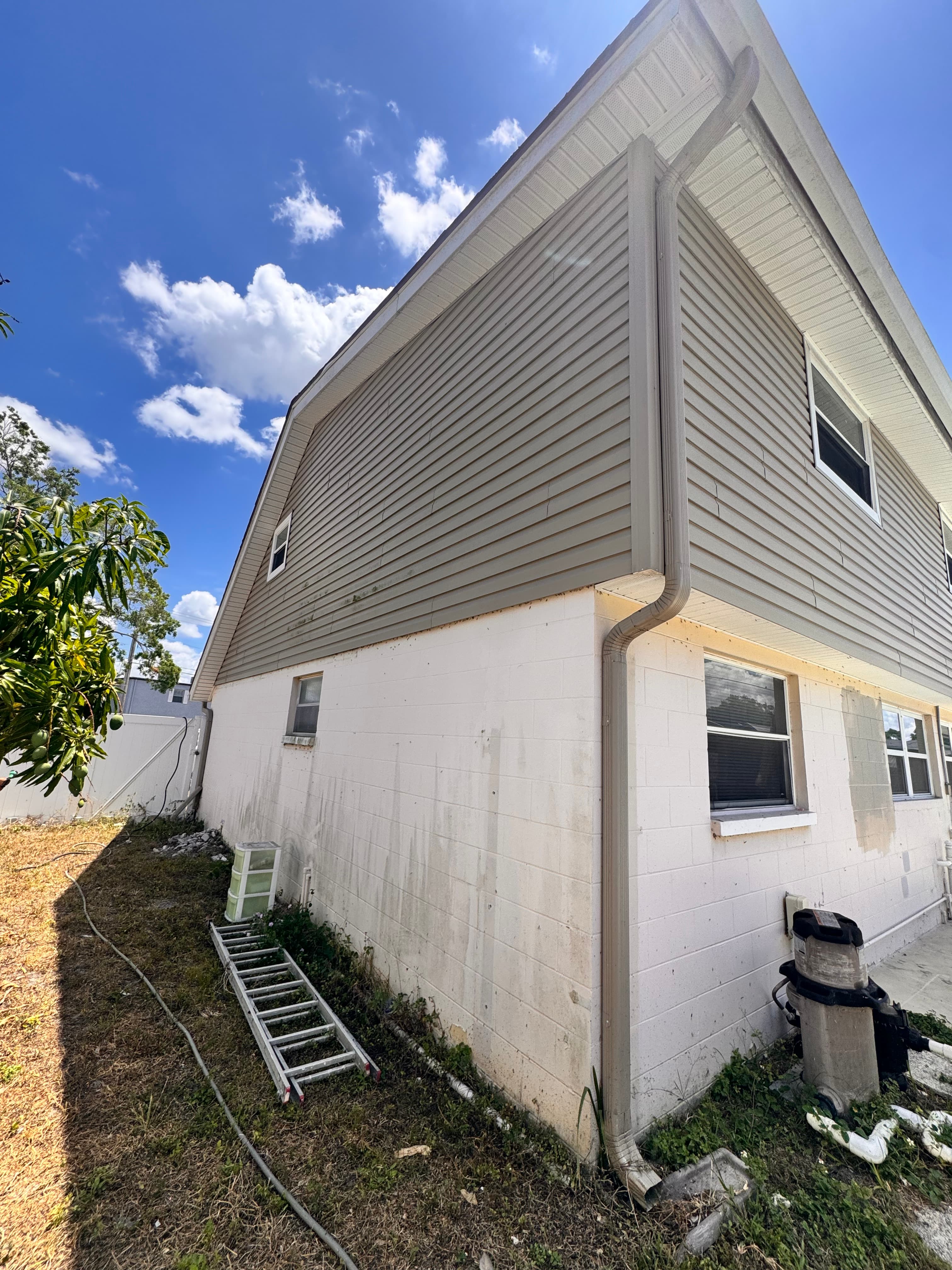 Before photo of residential home exterior side view with original paint before full repaint